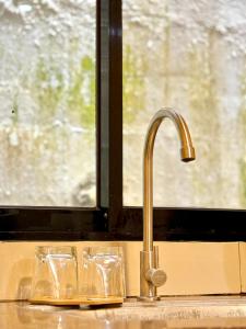 a sink with a faucet next to a window at La Greta El Nido Apartments in El Nido +58 photos