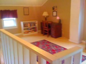 a room with a crib with a rug on the floor at Historic Vacation Rental on Acres of Farmland near Aloha State Park, Michigan in Alverno
