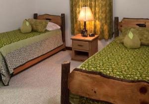 una camera da letto con due letti e un tavolo con una lampada di Family-Friendly Cabin Rental for Six on Nantahala Mountain with White Water Rafting in North Carolina a Aquone