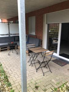 a patio with a table and chairs and a couch at MP Apartments in Hückelhoven