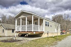 a house with a large porch on the side of it at Great Vacation Complex for the Best Pennsylvania Glamping in Poyntelle