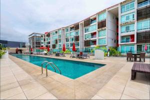 a swimming pool in front of a building at Feel at home in paradise in Nuevo Vallarta