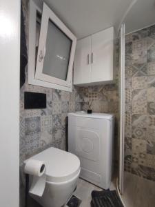 a bathroom with a white toilet and a cabinet at Urban Cocoon, Nice & Easy in Athens