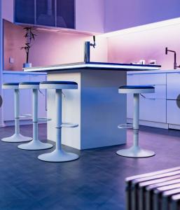 a kitchen with three bar stools and a counter at Entire 4 Room Boutique Hotel - Central Dunedin in Dunedin +35 photos