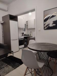 a kitchen with a table and chairs in a room at Urban Cocoon, Nice & Easy in Athens +9 photos