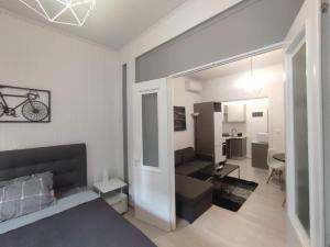 a bedroom with a bed and a living room at Urban Cocoon, Nice & Easy in Athens