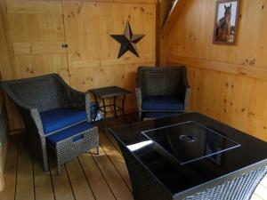 a room with two chairs and a star on the wall at Romantic Cabin Rental Overlooking Otter Creek in the Adirondacks of Upstate New York in Greig