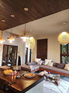 a living room with a couch and a table at Prana Siargao Resort in General Luna