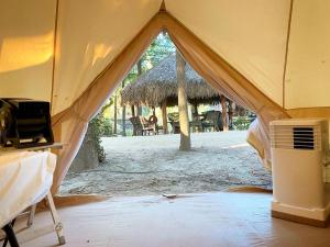 a room with a tent with a tv in it at Relaxation and Fun Combined Glamping Tents M & In-Water Picnic Table L in Kingsbury, TX in Second Crossing