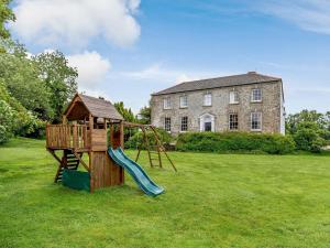 a playground with a slide and a house at 4 Bed in Padstow PENDA in Egloshayle