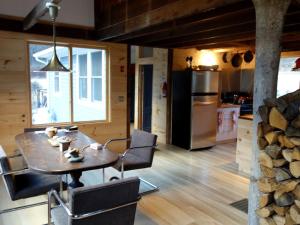 a kitchen and dining room with a table and chairs at Charming Cabin Getaway with a Wood-Burning Stove in Chesterfield, Massachusetts in South Worthington