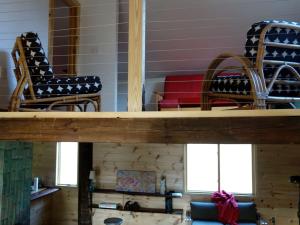 two chairs and a table in a room at Charming Cabin Getaway with a Wood-Burning Stove in Chesterfield, Massachusetts in South Worthington +9 photos