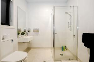 a bathroom with a shower and a toilet and a sink at 3 Bedroom 3 Bath Accessible Bathrooms in Melton South