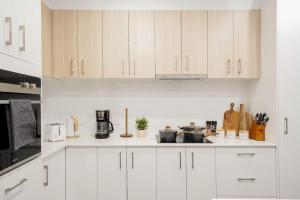 a white kitchen with white cabinets and appliances at 3 Bedroom 3 Bath Accessible Bathrooms in Melton South +13 photos