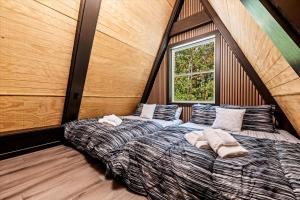 a bedroom with two beds and a window at Modern A-Frame Cabin with Breathtaking Views of the Smoky Mountains, Perfect for Families or Groups in Hartford