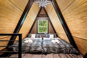 a bedroom with two beds in a room with a window at Modern A-Frame Cabin with Breathtaking Views of the Smoky Mountains, Perfect for Families or Groups in Hartford