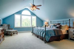 a blue bedroom with a bed and a ceiling fan at Incredible Villa Rental for Groups with Pool near Mt Vernon, Texas in Hopewell +46 photos