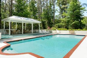 a swimming pool with a gazebo at Incredible Villa Rental for Groups with Pool near Mt Vernon, Texas in Hopewell