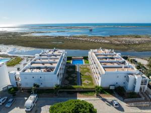 an aerial view of a resort with the ocean at Brisa Da Ria Apartment, Formosa Village in Fuzeta