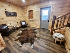 a room with a log cabin with a wooden floor at Lakeview Cabin by Tappan Lake, Perfect for Groups with Hot-Tub in Ohio in Deersville
