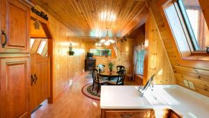 a large room with a table in a wooden house at Romantic Forest Cabin with Amazing Private Deck and Spa in Ohio in Walnut Creek