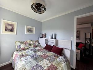 a bedroom with a bed and a clock on the wall at Charming Tiny Cottage in the Woods near Center Hill Lake for a Romantic Getaway near Baxter, Tennessee in Johnsons Chapel