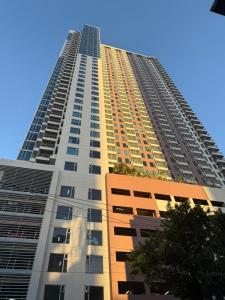 a tall building with a blue sky in the background at Condo near US Embassy and St Lukes Ermita in Manila