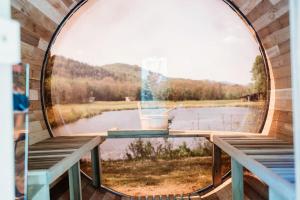 a circular window with a view of a lake at Idyllic Safari Tent with Sauna and Amazing Views in North Woodstock, New Hampshire in Woodstock