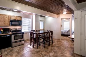 a kitchen with a table and chairs in a room at Spacious Log Cabin Rental for Family Vacations in Texas in Nacogdoches