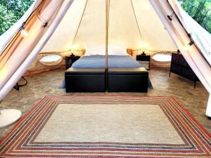 a bedroom in a tent with a bed in it at Fern Dell - Air Conditioned in Hot Springs National Park, Arkansas in Hot Springs