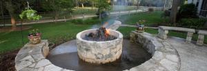 a fire pit in a yard with two flower pots at Simple and Cozy Cabin Rental on Private Ranch Retreat near Austin, Texas in Waelder +8 photos