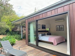 a bedroom in a house with a sliding glass door at RYE HOLIDAY AWAY in Rye