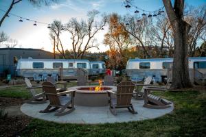 a patio with chairs and a fire pit and two rvs at Modern Airstream Stay in Downtown Prescott AZ Near Whiskey Row in Prescott