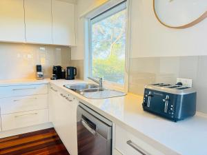 a kitchen with a sink and a stove at RYE HOLIDAY AWAY in Rye +63 photos