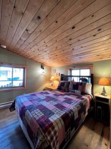 a bedroom with a large bed and wooden ceilings at Secluded Cabin Rental with Mountain Views in Clark, Northern Colorado in Columbine