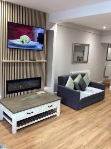 a living room with a couch and a flat screen tv at Flat in Maerdy in Maerdy