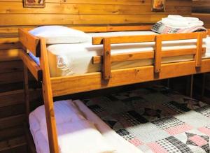 two bunk beds in a room with a wall at Rustic Cabin Rental in the Wilderness near Beckley, West Virginia in Hico +4 photos