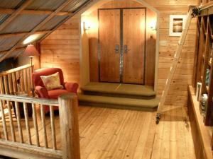 a room with a staircase and a chair in a house at Immaculate Cabin Rental with a Hot Tub next to Lake Pend Oreille in Bonner County, Idaho in Broten +10 photos