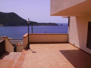 a balcony of a building with a view of the water at Campese Apartments in Campese