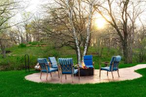 a group of four chairs sitting around a fire pit at Lakefront Cottage Fully Equipped with Excellent Location in Saint Croix Falls, Wisconsin in Saint Croix Falls