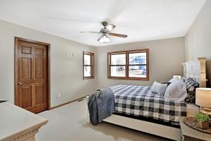 a bedroom with a bed and a ceiling fan at Lakefront Cottage Fully Equipped with Excellent Location in Saint Croix Falls, Wisconsin in Saint Croix Falls