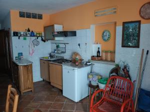 a kitchen with a stove and a white refrigerator at Parva Domus in Campolattaro
