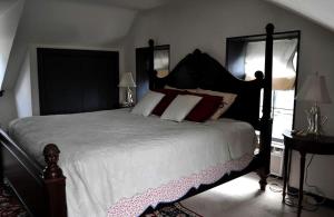 a bedroom with a large bed with red and white pillows at Private Bed and Breakfast Accommodation for Two near Doylestown, Pennsylvania in Buckingham