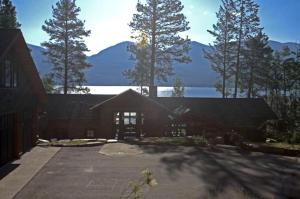 a house with a view of a lake and mountains at Lakeside Vacation Rental with Stunning Views and Spacious Interior on Flathead Lake, Montana in Finley Point
