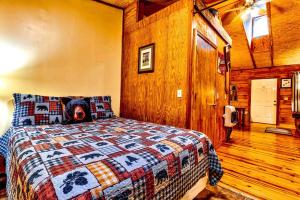ein Schlafzimmer mit einem Bett mit einem Bärenkissen darauf in der Unterkunft Cozy Creekside Cabin Rental near Cherokee, North Carolina in Cherokee