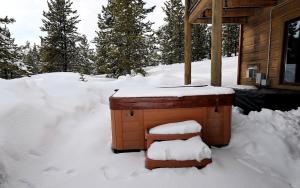 a sauna in the snow next to a cabin at Family-Friendly Cabin Rental with Lone Peak Views in Big Sky in Big Sky Mountain Village