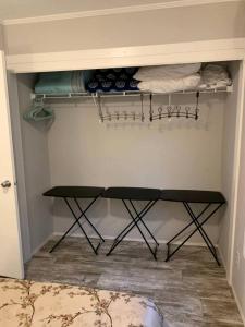 a walk in closet with a shelf and a table at Picturesque Cottage with Fire Pit in Dunnellon, Florida in Dunnellon