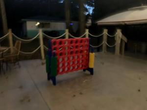 ein roter Einkaufswagen, der auf dem Boden in einem Zimmer steht in der Unterkunft Picturesque Cottage with Fire Pit in Dunnellon, Florida in Dunnellon