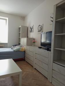 a small bedroom with a bed and a television at Flat Břeclav City Center in Břeclav