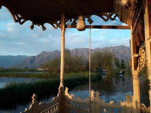 a room with a view of a river and mountains at HZP Yacht in Srinagar
